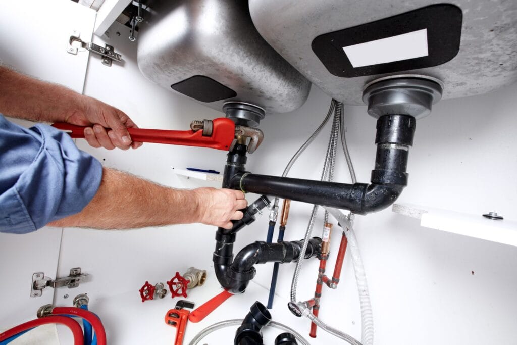 Delray Beach Plumbing Pros fixing under sink plumbing and drain pipes
