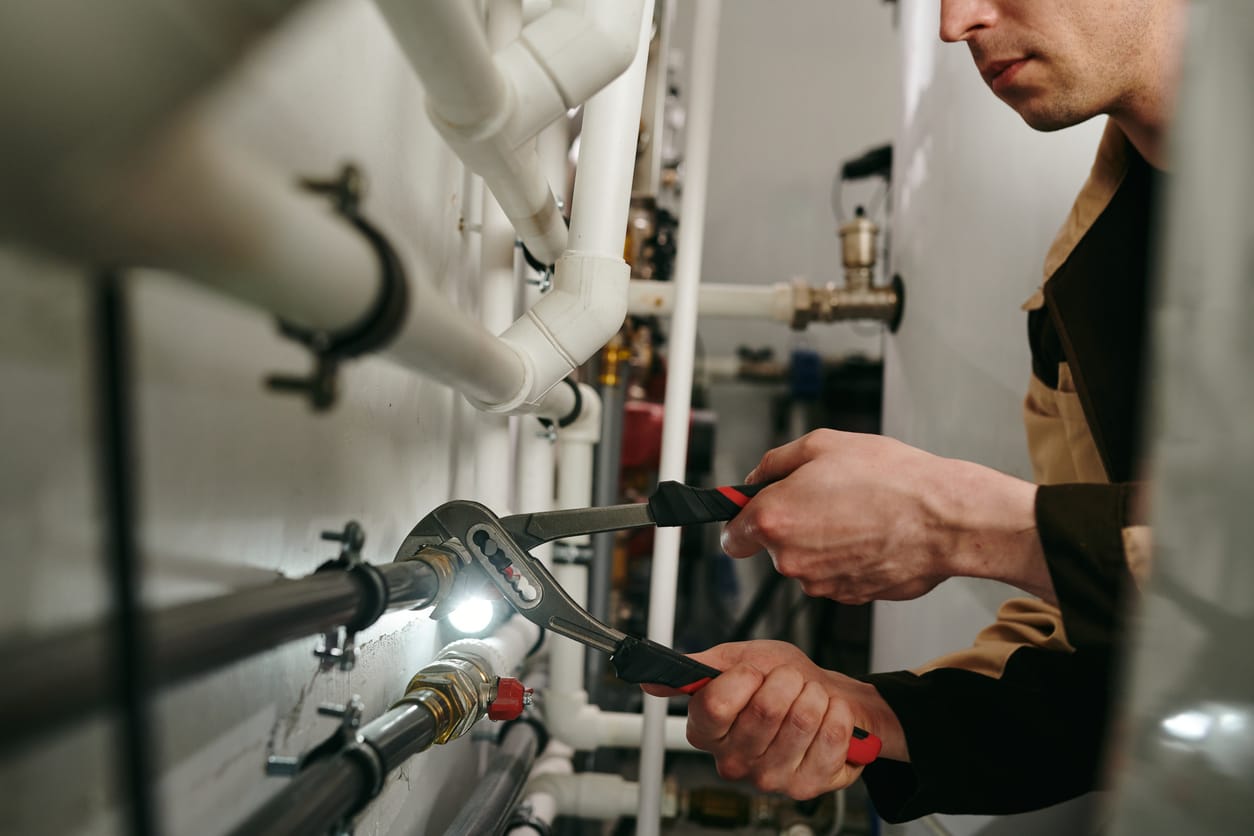 Plumbers maintaining commercial plumbing pipes in Delray Beach