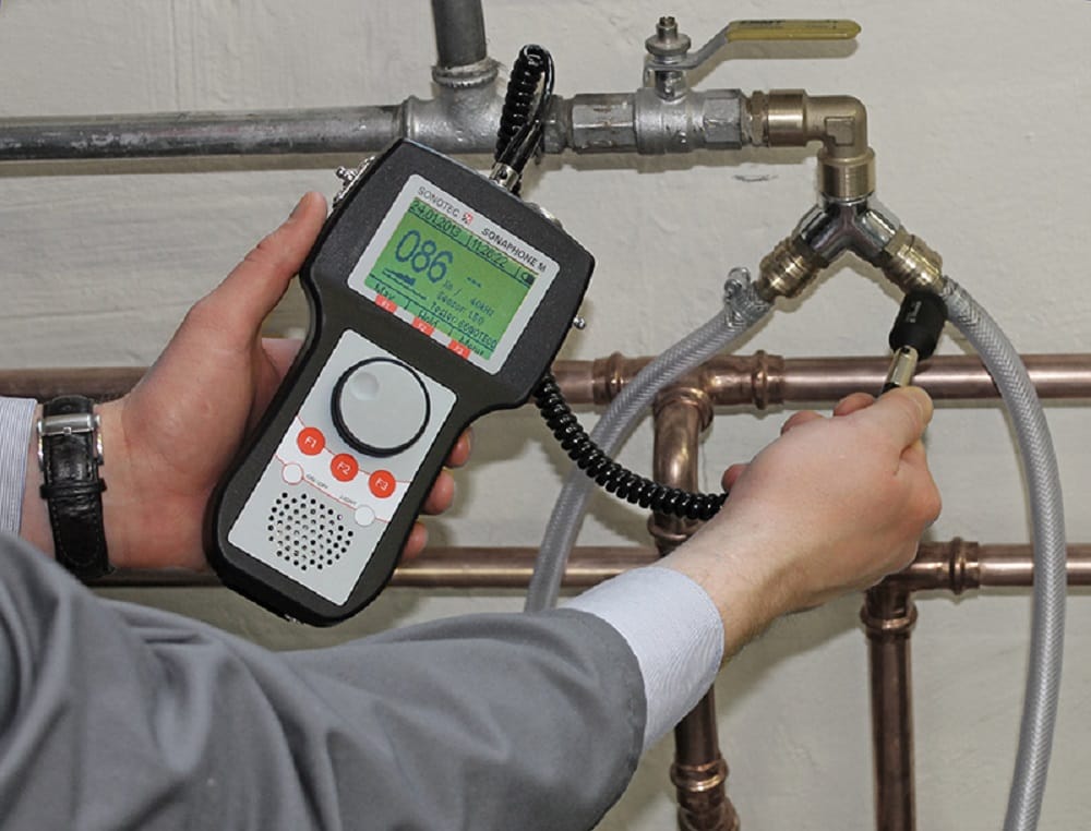 Plumber testing pipes with electronic leak detection equipment in Delray Beach