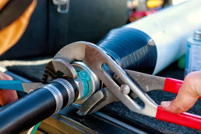 Technician tightening an industrial pipe connection in Delray Beach
