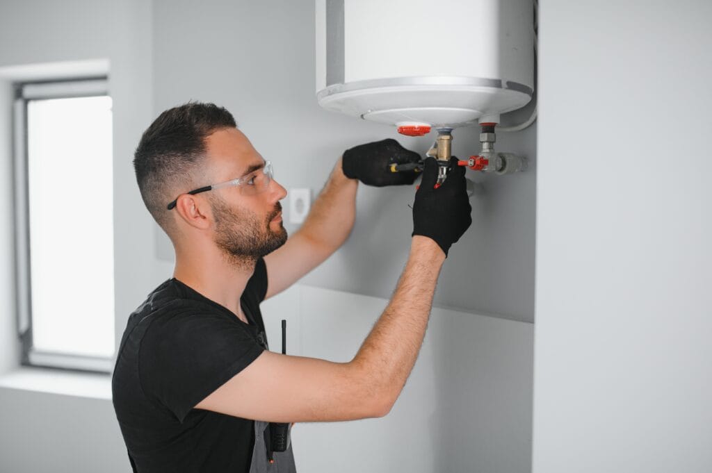 Technician performing water heater maintenance in Delray Beach